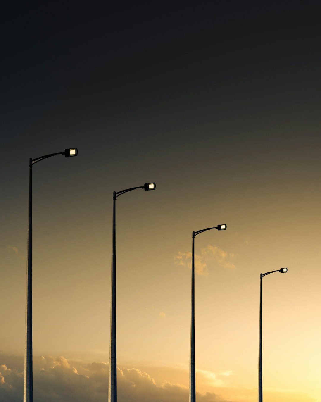 3 light post light turned on during night time