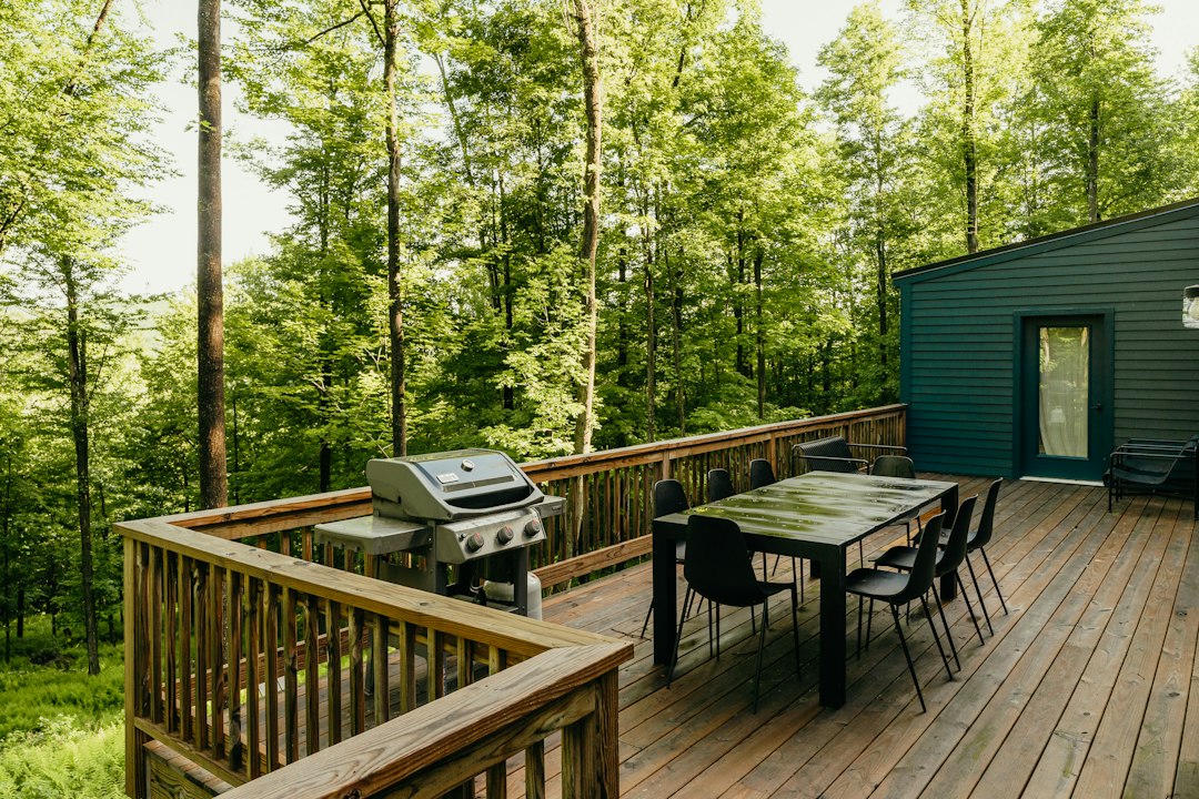 a wooden deck with a table and chairs on it