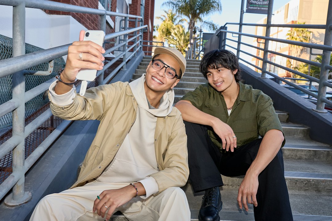 Two young men taking a selfie on outdoor stairs
